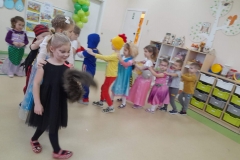 Dzieci przebrane za postacie bajkowe utworzyły pociąg, tańczą do muzyki.
