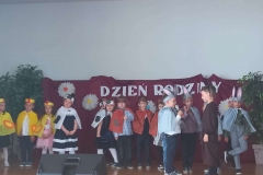 Dzieci stoją na scenie. Ubrane w żółte, biało - czarne stroje.